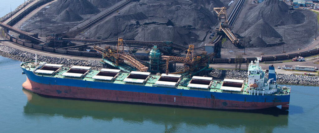 A dry bulk ship getting loaded at facility 